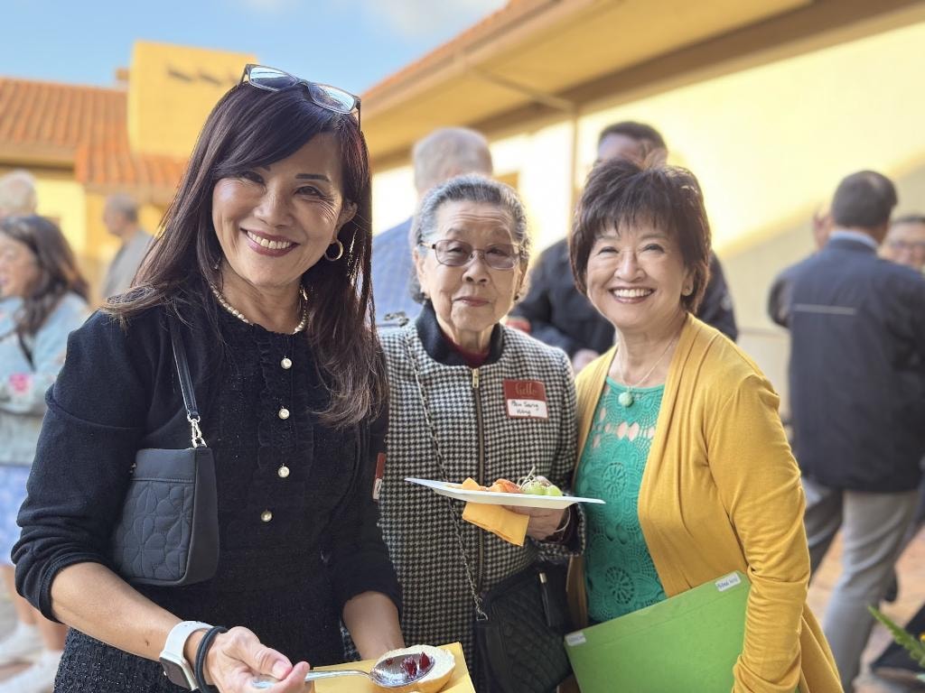 Sue Chan with community members at outdoor event