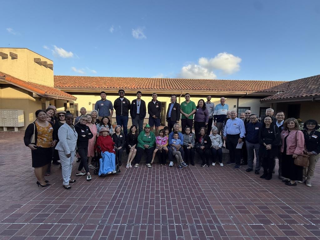Large group photo at campaign event courtyard
