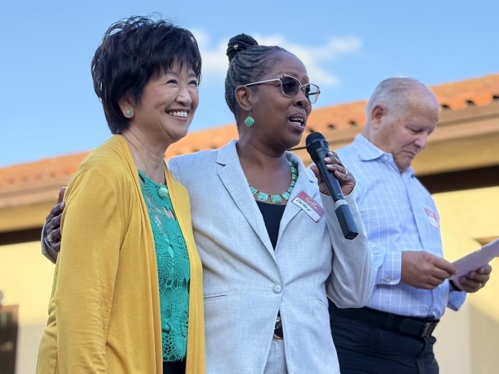 Sue Chan with endorser speaking at event