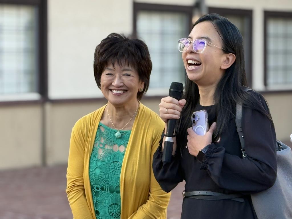 Sue Chan with endorser speaking at event