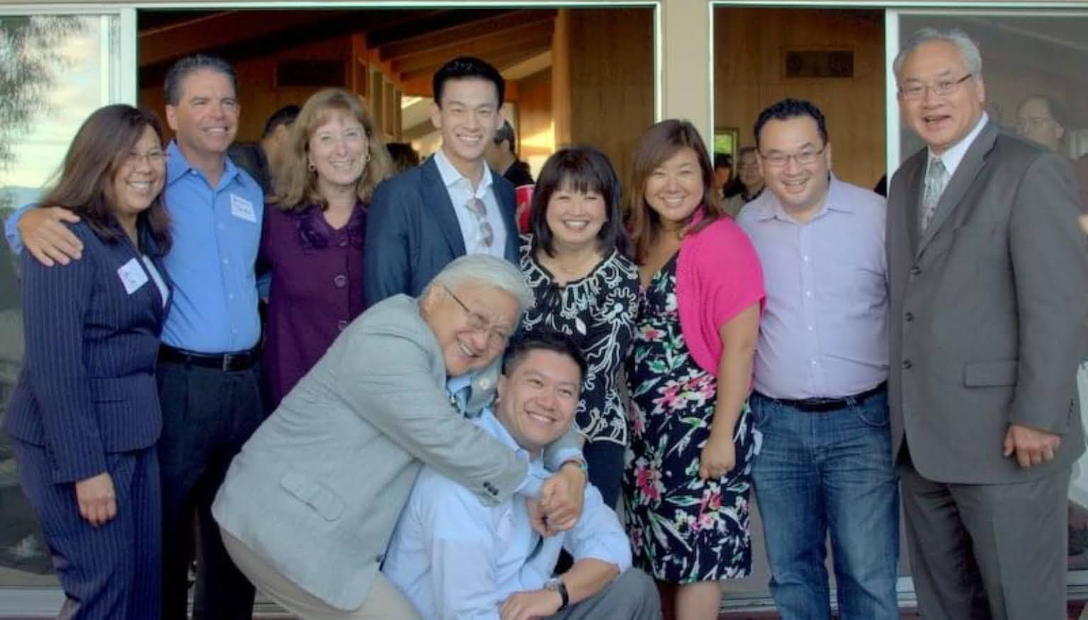 Sue Chan with group at indoor event